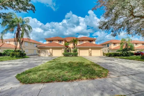 a living room with furniture a chandelier and a flat screen tv