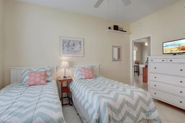 a bathroom with a toilet a sink a mirror a vanity and shower