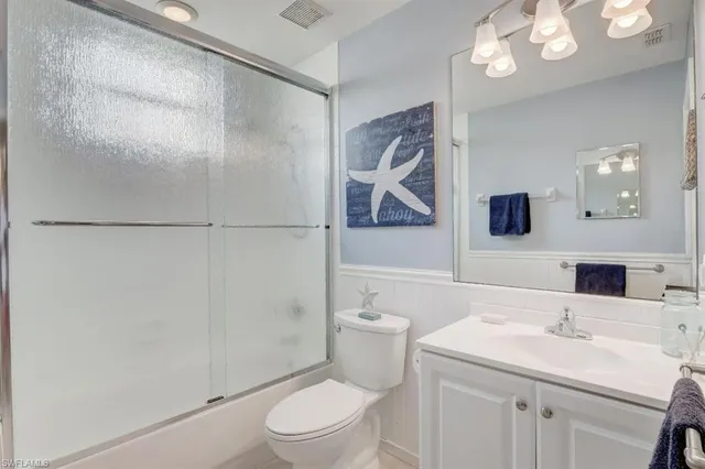 a bathroom with a double vanity sink mirror and shower