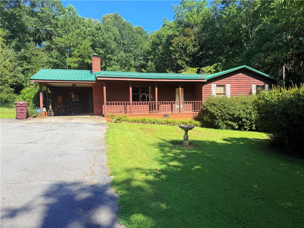 407 Seawright Drive Pendleton, SC 29670 - Photo 1 of 29 A classic rustic exterior showcases a metal roof and a spacious covered front porch.