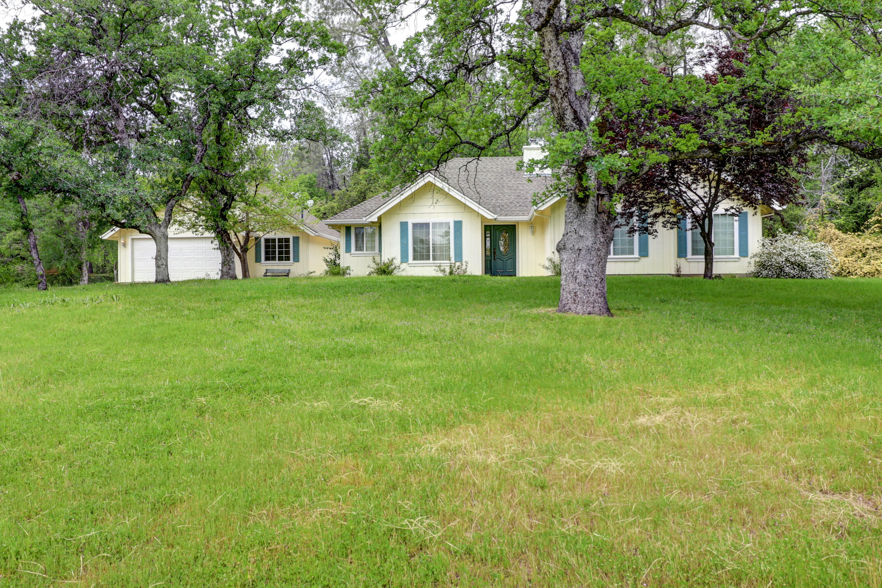 a front view of a house with a garden