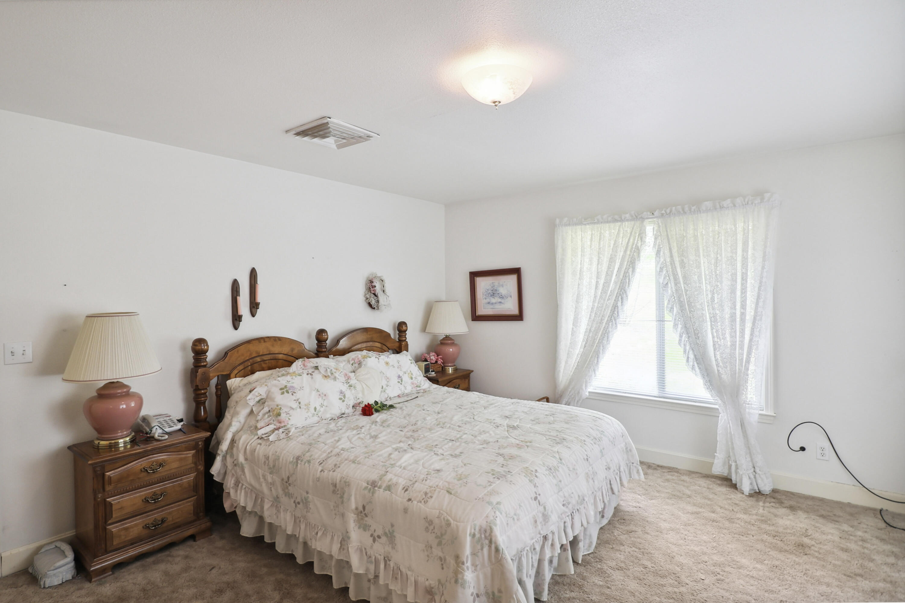 9400 Placer Road Redding, CA 96001 - Photo 22 of 52 a bedroom with a bed and a window