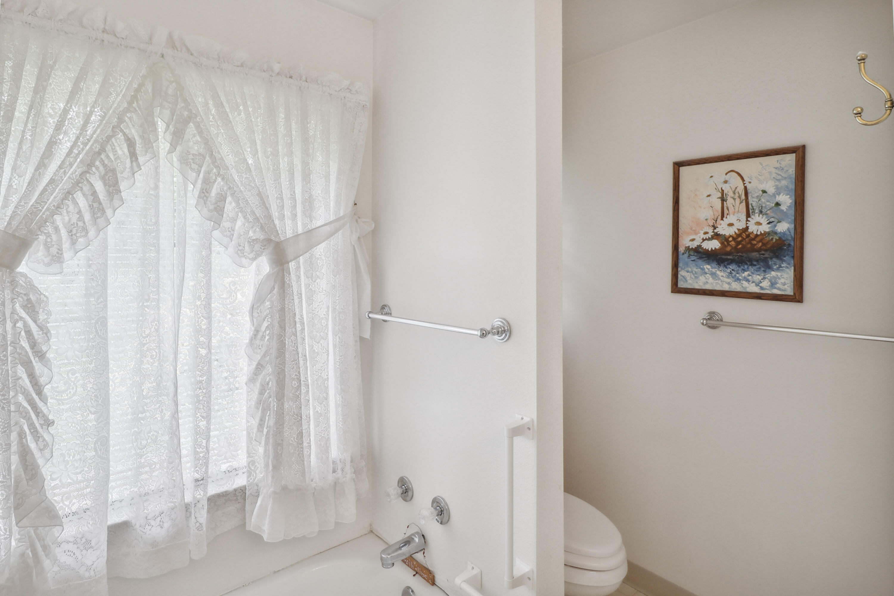 9400 Placer Road Redding, CA 96001 - Photo 26 of 52 a white toilet sitting next to a shower curtain