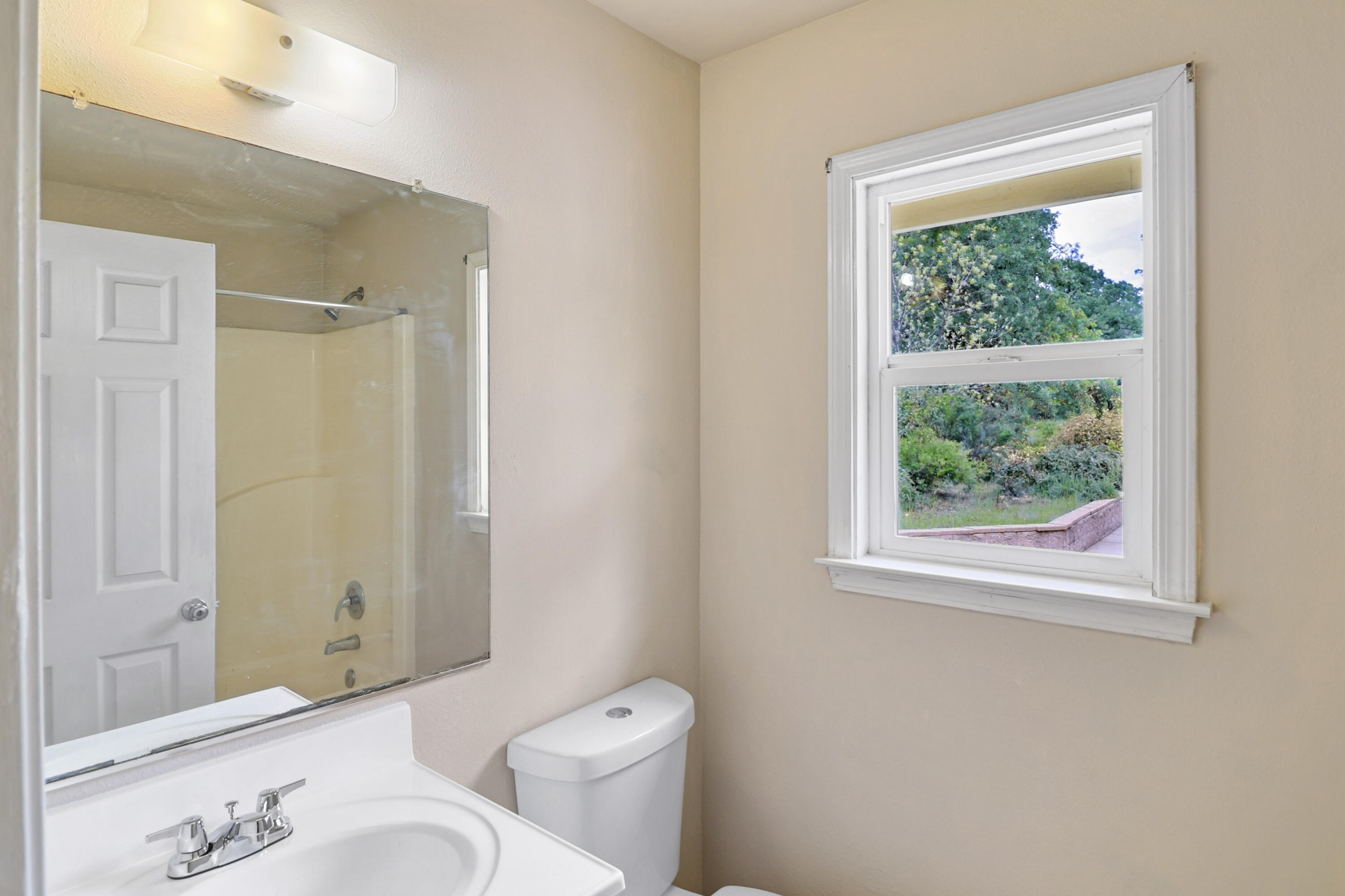 9400 Placer Road Redding, CA 96001 - Photo 35 of 52 a bathroom with a granite countertop sink toilet and shower