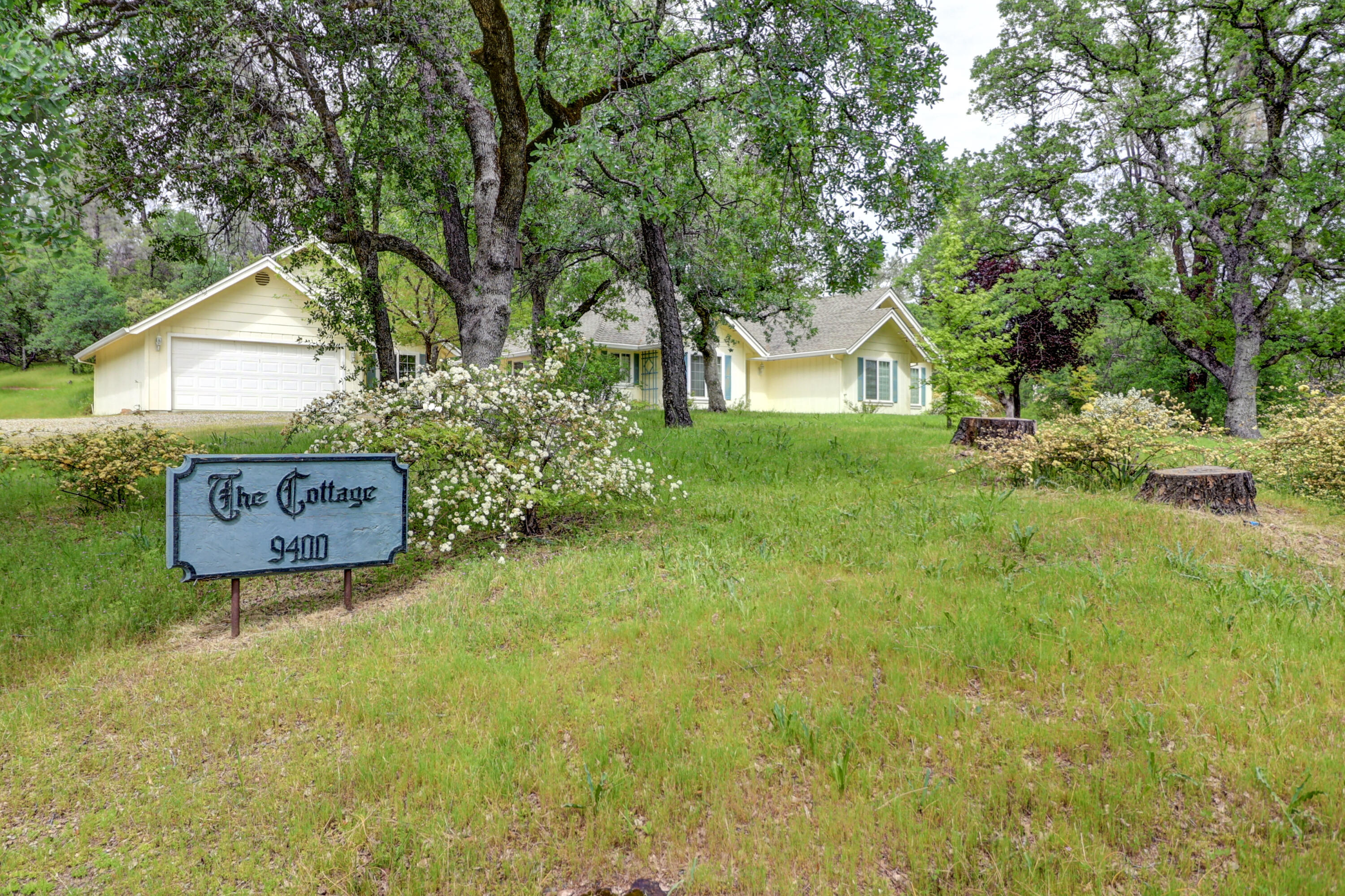 9400 Placer Road Redding, CA 96001 - Photo 37 of 52 a view of a house with a yard and a tree
