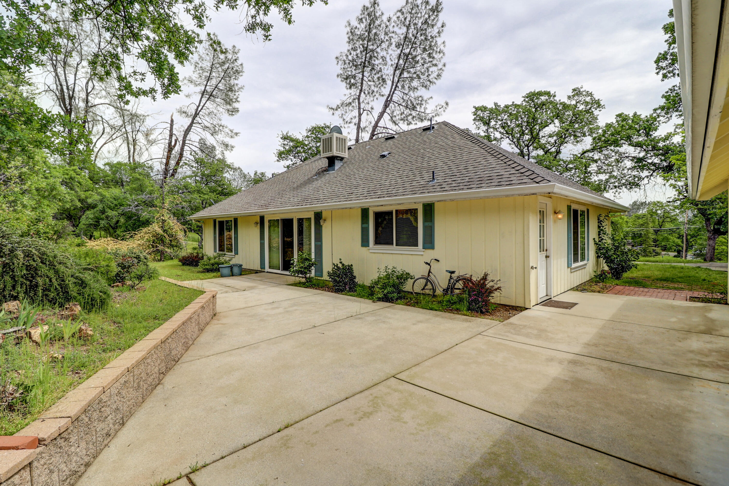 9400 Placer Road Redding, CA 96001 - Photo 47 of 52 a front view of a house with a garden