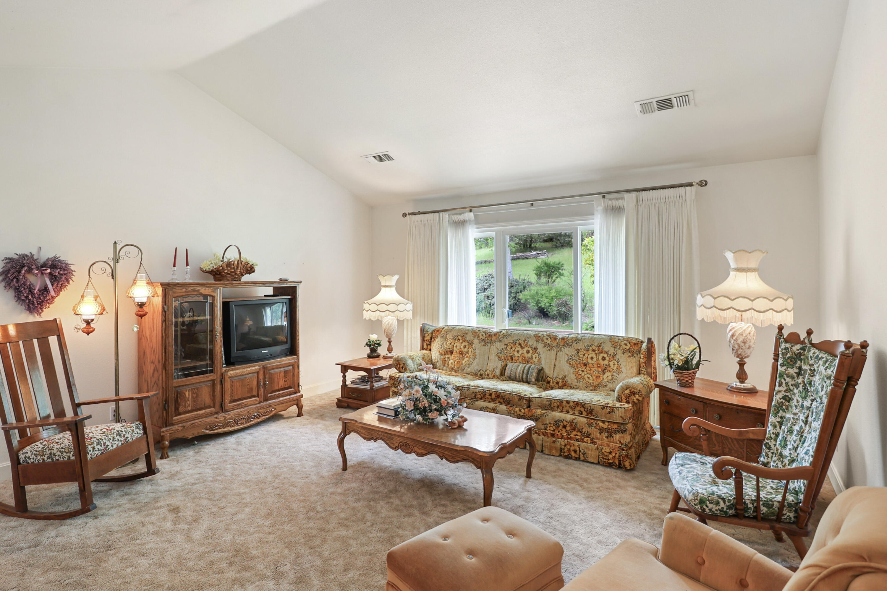 9400 Placer Road Redding, CA 96001 - Photo 7 of 52 a living room with furniture a rug and a chandelier