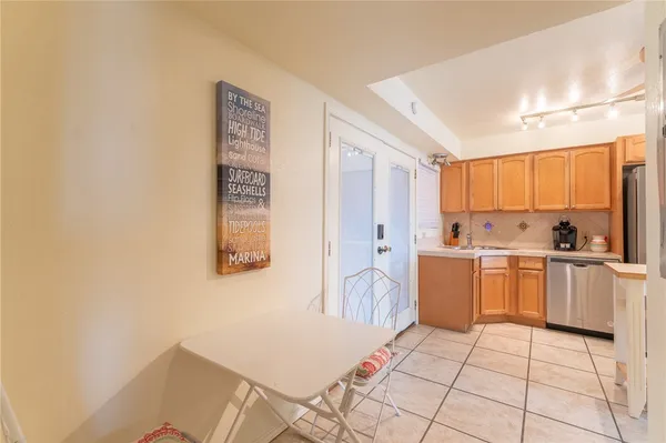 a kitchen with a sink a stove top oven a counter space and cabinets