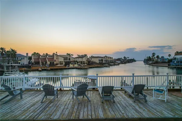 a view of balcony and city with wooden floor