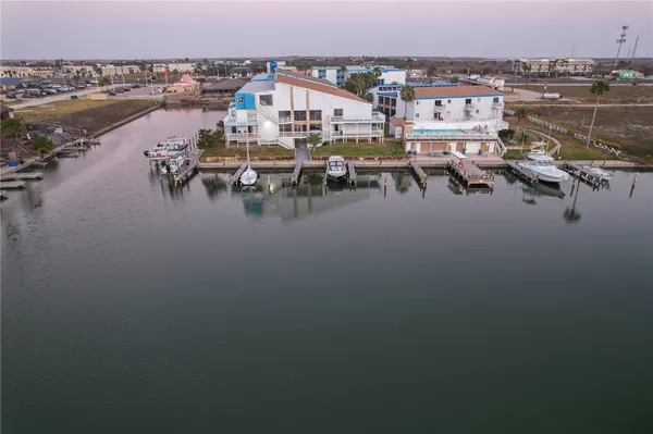 a view of a terrace with lawn chairs