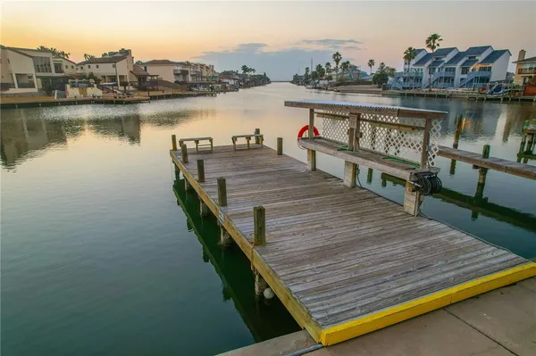 a view of a balcony with wooden floor and lake view
