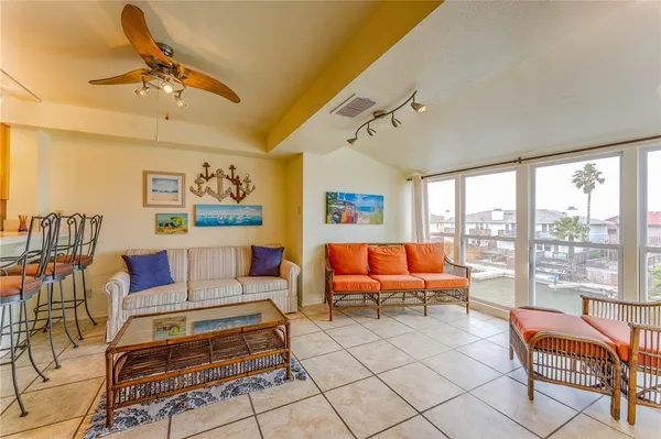 a living room with furniture and a floor to ceiling window