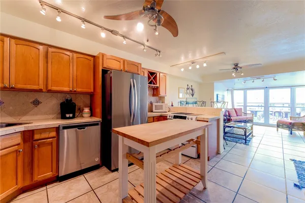 a kitchen with a sink a counter top space stainless steel appliances and cabinets