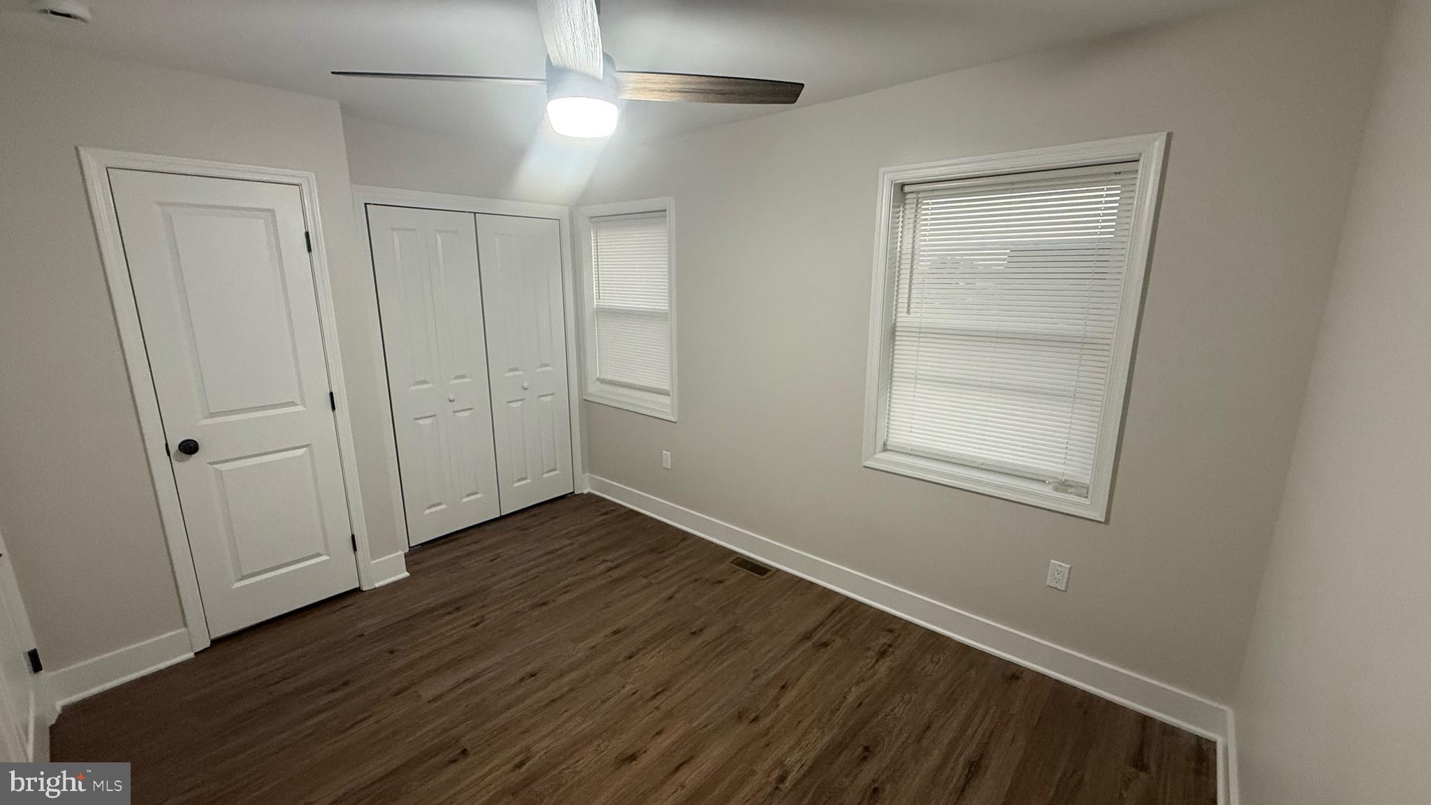 3802 Rokeby Road Baltimore, MD 21229 - Photo 14 of 16 an empty room with wooden floor closet and windows