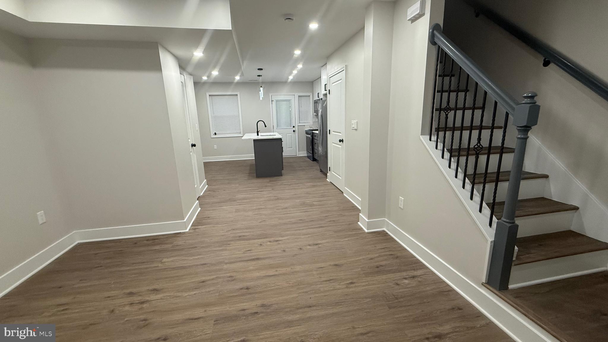 3802 Rokeby Road Baltimore, MD 21229 - Photo 4 of 16 a view of a hallway with wooden floor and staircase