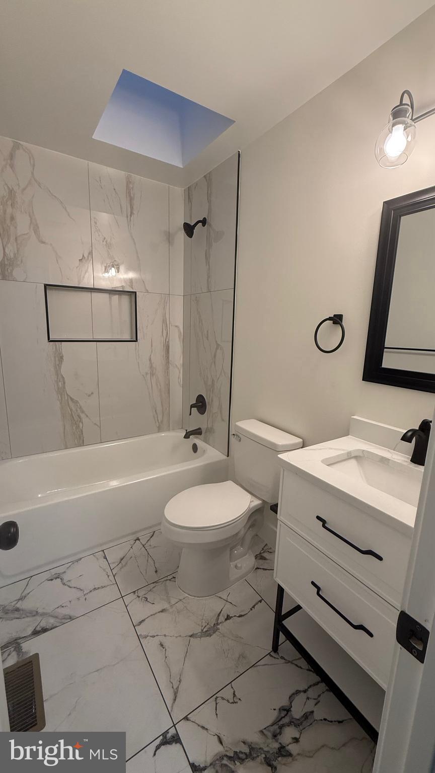 3802 Rokeby Road Baltimore, MD 21229 - Photo 7 of 16 a bathroom with a sink a toilet and shower