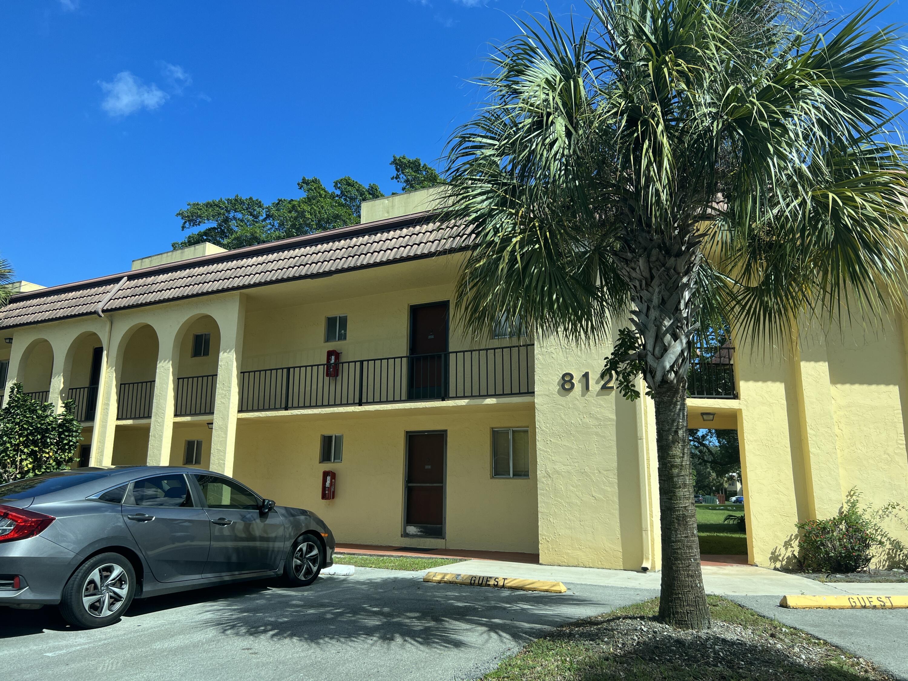 812 Southwest 9th St Circle, Unit 103 Boca Raton, FL 33486 - Photo 13 of 14 a car parked in front of a house