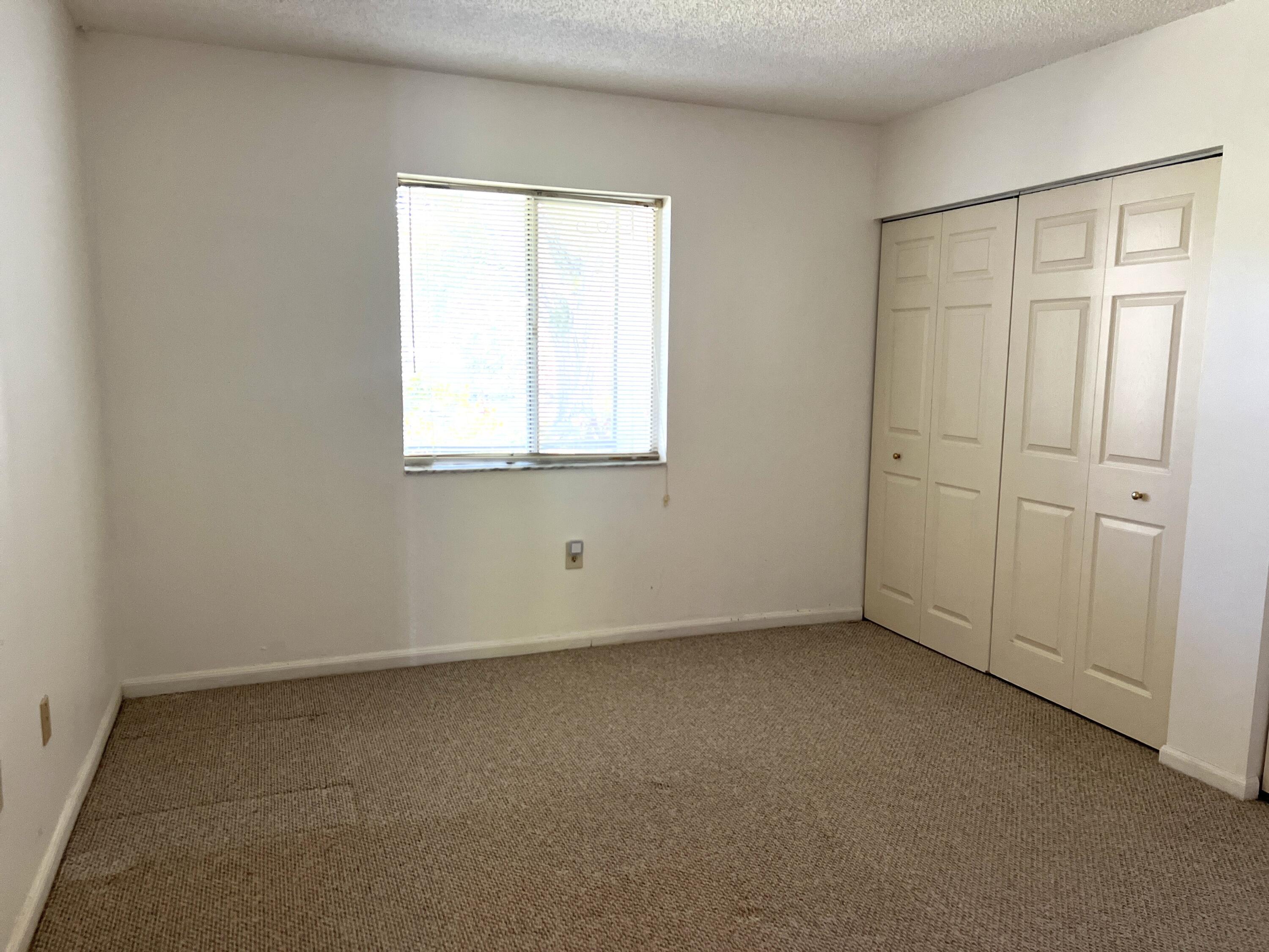 812 Southwest 9th St Circle, Unit 103 Boca Raton, FL 33486 - Photo 7 of 14 an empty room with a window