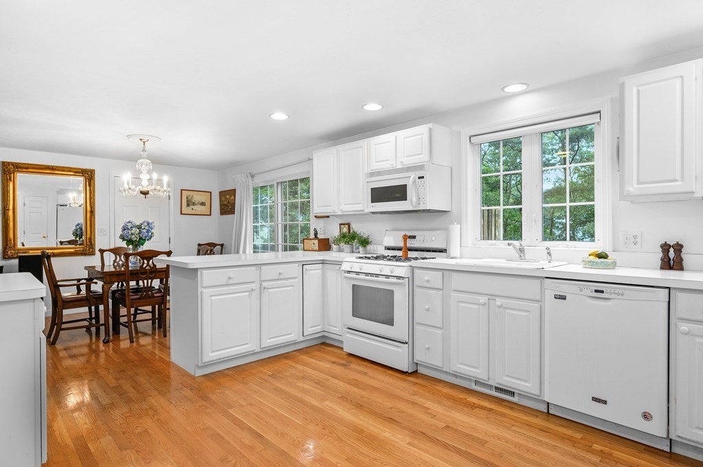 120 Queen Anne Road Harwich, MA 02645 - Photo 1 of 35 a kitchen with a sink cabinets and dining table chair