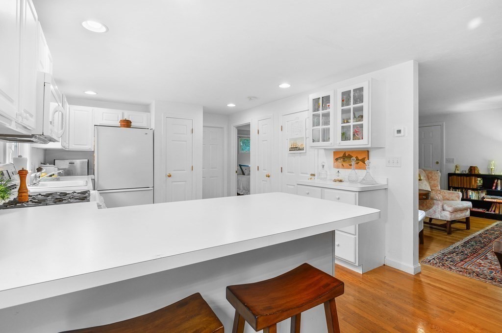 120 Queen Anne Road Harwich, MA 02645 - Photo 11 of 35 a kitchen with stainless steel appliances a refrigerator and a stove top oven