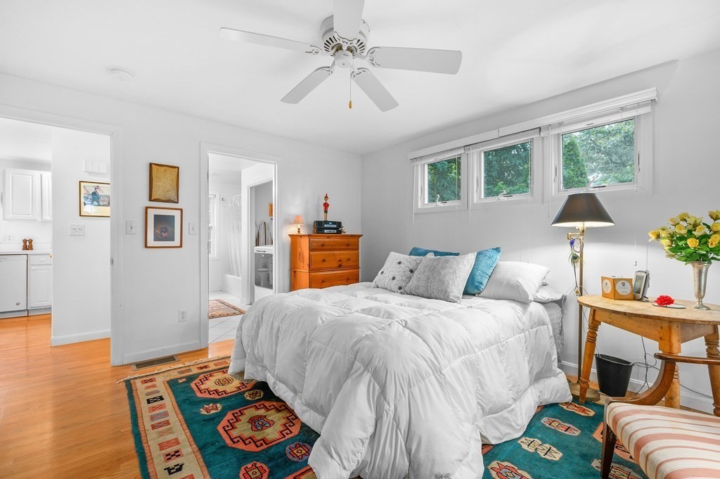 120 Queen Anne Road Harwich, MA 02645 - Photo 13 of 35 a bedroom with a bed and wooden floor