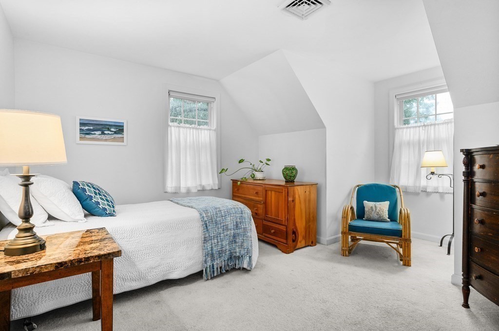120 Queen Anne Road Harwich, MA 02645 - Photo 21 of 35 a bedroom with a bed and a chair