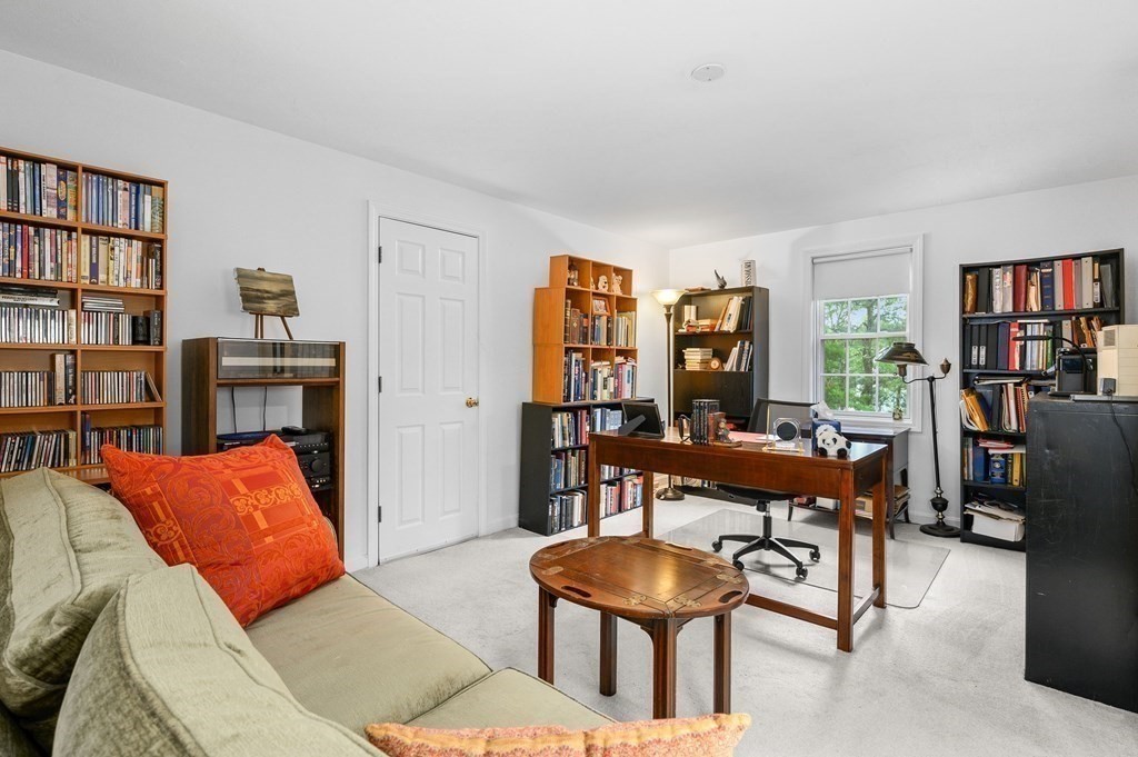 120 Queen Anne Road Harwich, MA 02645 - Photo 22 of 35 a living room with furniture a bookshelf and a window