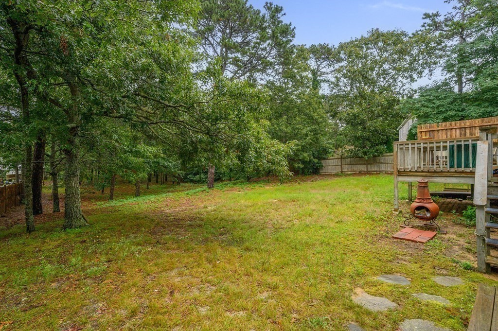 120 Queen Anne Road Harwich, MA 02645 - Photo 29 of 35 a view of a deck with a table and chairs