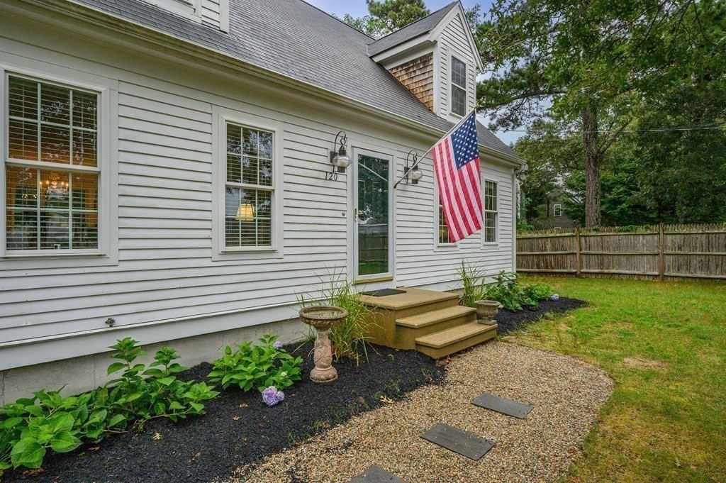 120 Queen Anne Road Harwich, MA 02645 - Photo 33 of 35 a view of a house with a backyard and sitting area
