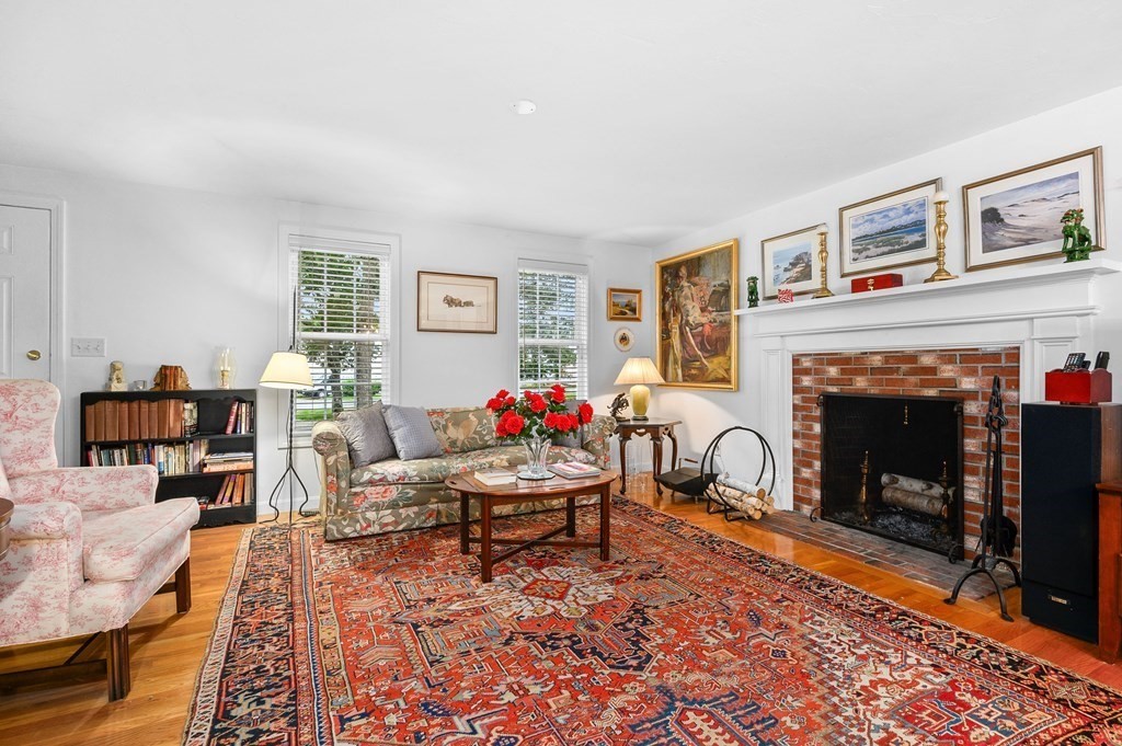 120 Queen Anne Road Harwich, MA 02645 - Photo 6 of 35 a living room with furniture and a fireplace