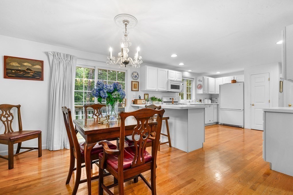 120 Queen Anne Road Harwich, MA 02645 - Photo 7 of 35 a kitchen with stainless steel appliances kitchen island granite countertop a table chairs and a refrigerator