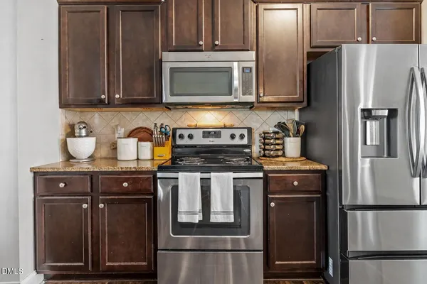a kitchen with stove a sink and refrigerator