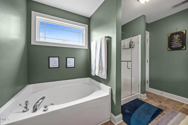 a bedroom with a bed dresser and a window