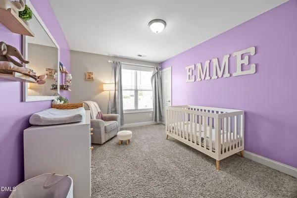 a bedroom with furniture and a baby crib