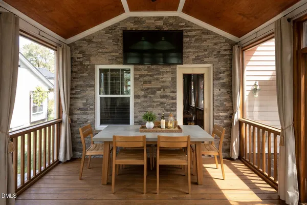 a living room with furniture and floor to ceiling windows