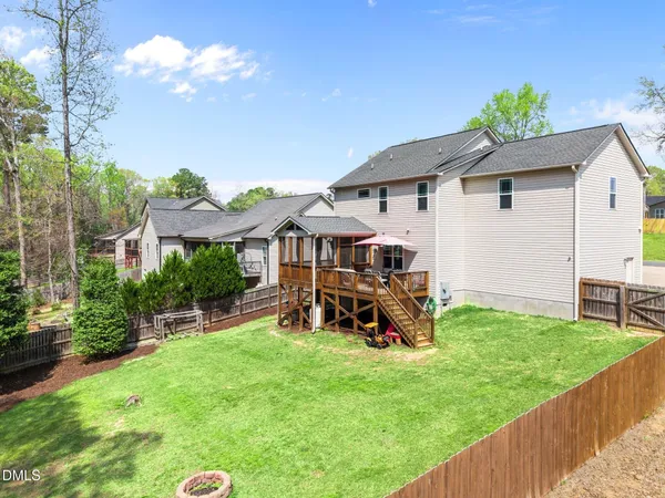 a view of a patio with a table and chairs under an umbrella
