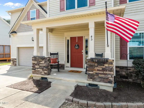 a view of a house with backyard porch and sitting area