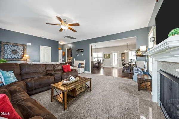 a bedroom with a bed a dresser and a window