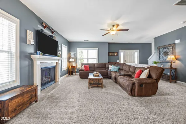 a living room with furniture and a fireplace