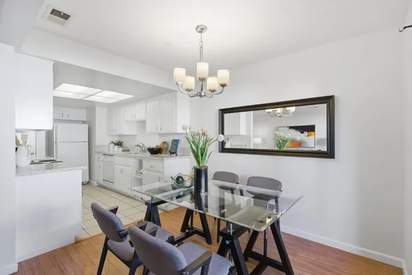 a view of a dining room with furniture wooden floor and a chandelier