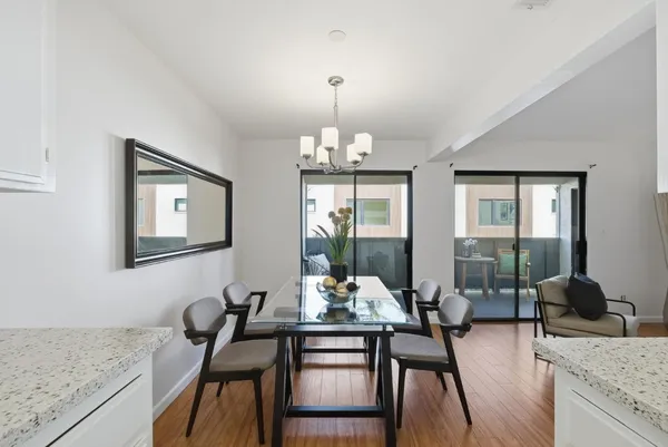 a view of a dining room with furniture wooden floor and chandelier