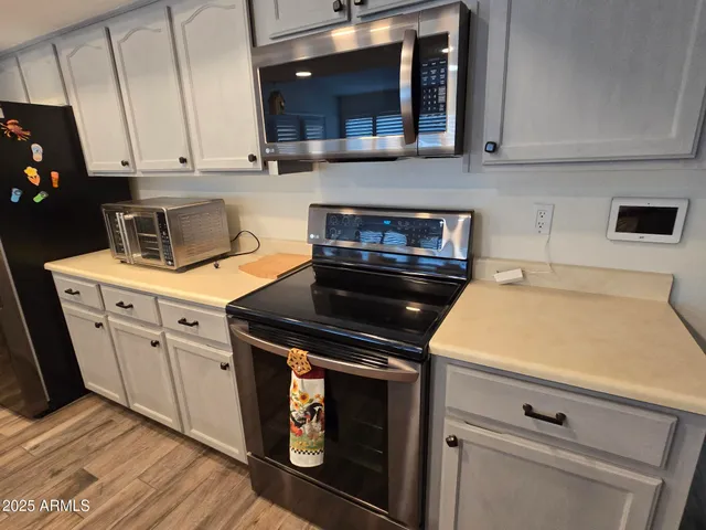 a kitchen with stainless steel appliances kitchen island granite countertop a sink and a stove