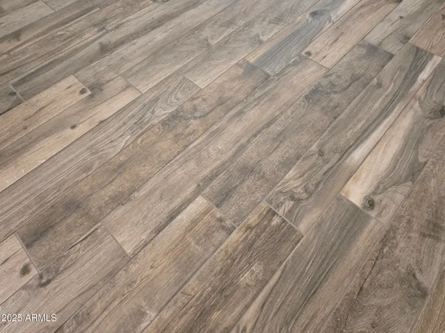 a view of a livingroom with wooden floor and a ceiling fan