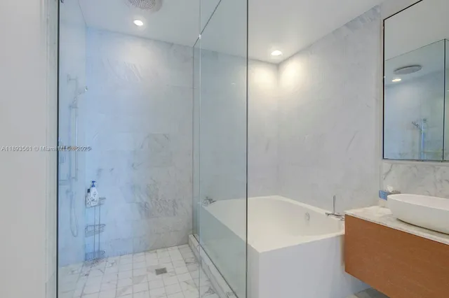 a bathroom with a bathtub and shower