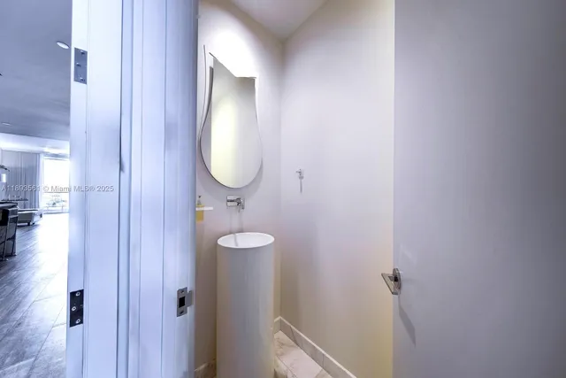 a bathroom with a mirror and a sink