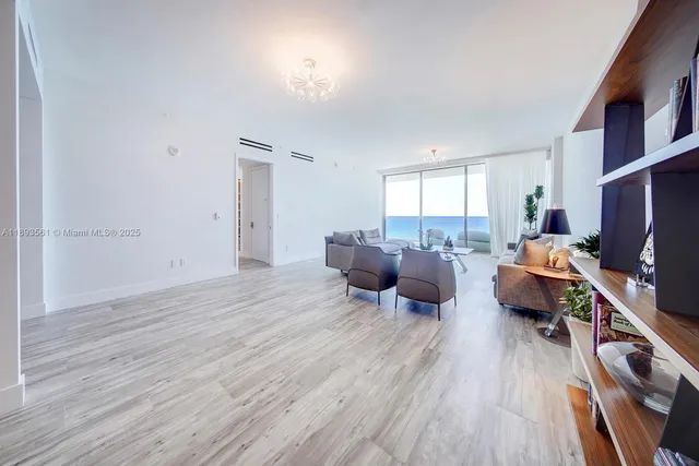 a living room with furniture a flat screen tv and a wooden floor
