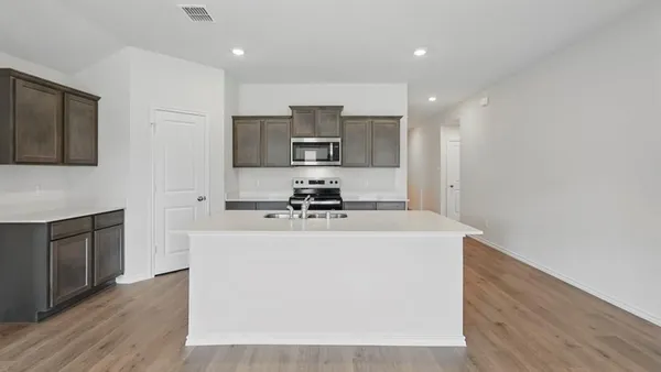 a kitchen with stainless steel appliances a sink stove and refrigerator