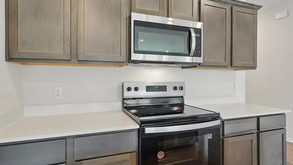 a kitchen with a stove and a microwave