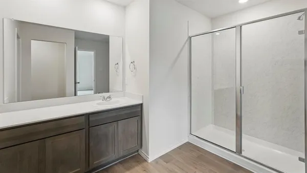 a bathroom with a double vanity sink and mirror