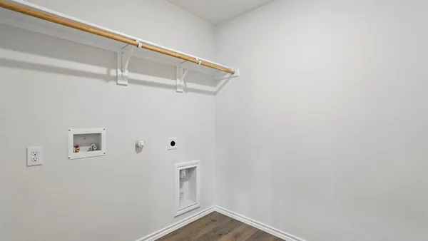 a view of kitchen with granite countertop cabinets and refrigerator